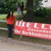 Coni Dubois stands next to a banner welcoming everyone to the Barkhamsted Lighthouse Reunion.