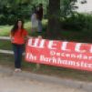 Coni Dubois stands next to a banner welcoming everyone to the Barkhamsted Lighthouse Reunion.